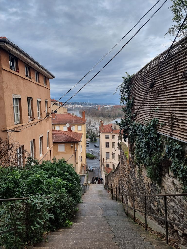 Scenic view of a narrow staircase in Lyon, showcasing historic architecture.